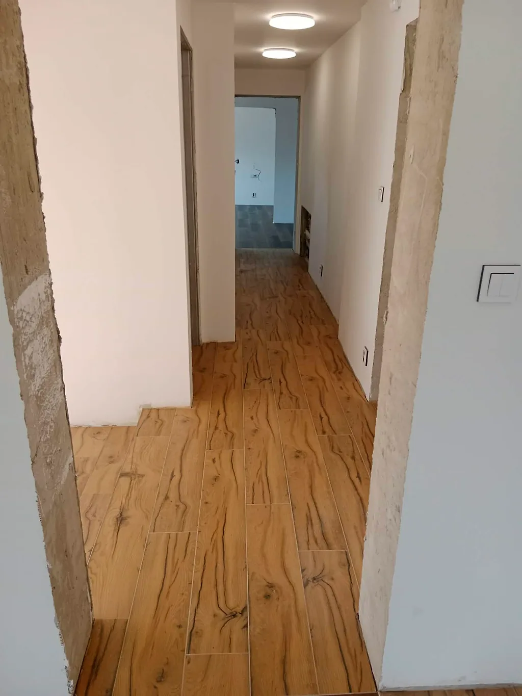Chodba s velkoformátovou dlažbou s dřevěnou kresbou
